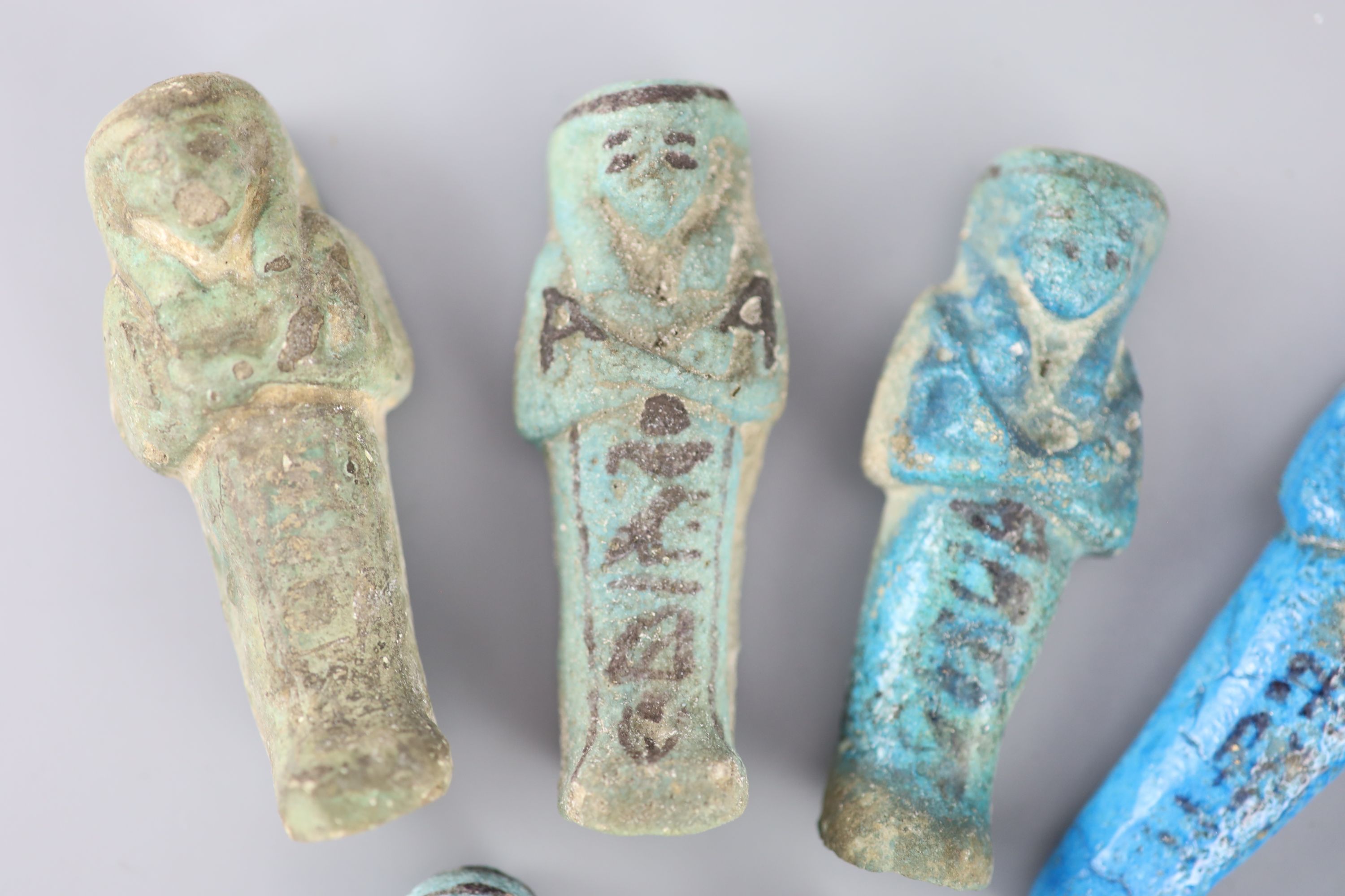 Five Egyptian turquoise glazed faience shabti and three fragments, New Kingdom to late period, Provenance - A. T. Arber-Cooke
